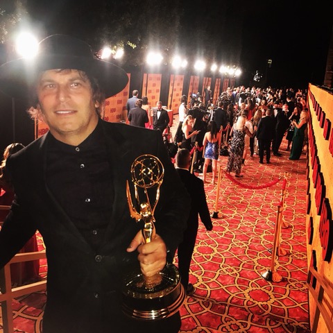 Nathan Ross, Emmy-winning producer, holding his Emmy Award